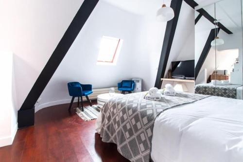 - une chambre avec un lit et deux chaises bleues dans l'établissement CIA - Avenue Hoche Studio, à Paris