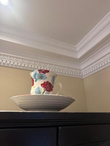 a vase sitting on top of a table with a plate at Ballea Castle in Cork