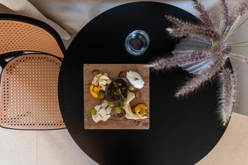a table with a plate of food on a table at Studios Kontos in Mikri Vigla