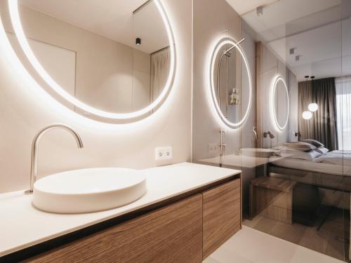 a bathroom with a sink and two mirrors at Haven Mountain Retreat in Sankt Johann im Pongau