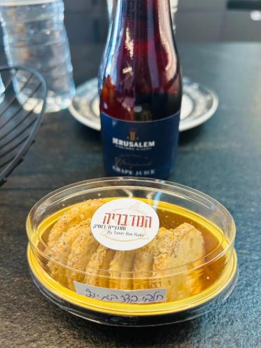 a plastic container of food and a bottle of wine at הפנינה השחורה in Mitzpe Ramon