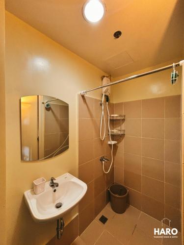 a bathroom with a sink and a mirror at Condo near Session Road with City View in Baguio