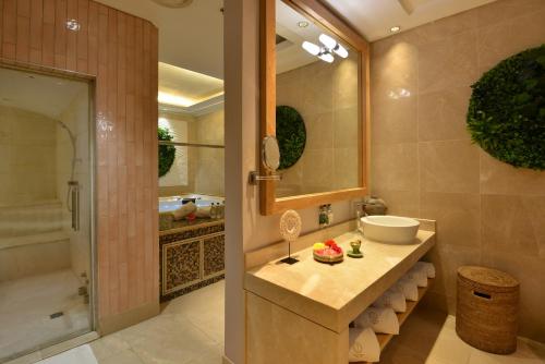 a bathroom with a sink and a shower and a tub at Taj Cape Town in Cape Town