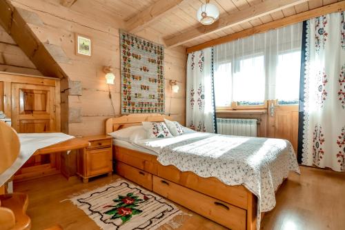 a bedroom with a bed in a wooden house at U Pabinów in Kościelisko