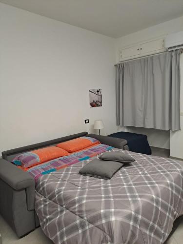 a bedroom with a large bed with orange pillows at San Leonardo Guest House in Castelbuono