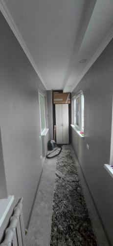 an empty hallway with a room with a ceiling and windows at Apartament in Bălţi