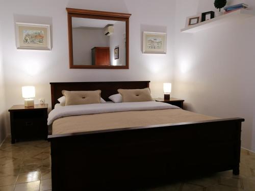 a bedroom with a large bed with a large mirror at Apartment Casa sul Mare in Tivat