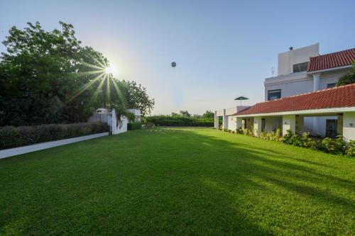 a large lawn in front of a building at Club Mahindra Kensville in Ahmedabad