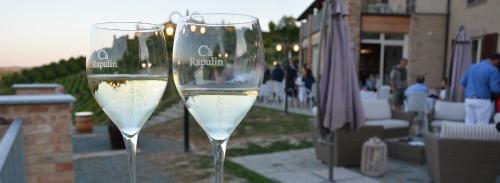 two glasses of white wine sitting on a patio at Ca'Rapulin in Calosso
