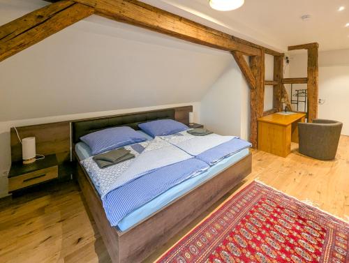 a bedroom with a bed and a rug at Ferienwohnungen - barrierefrei - im sanierten Gutshof in Lalendorf