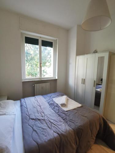 a bedroom with a large bed and a window at Venezuela in Milan