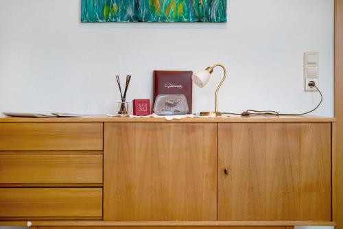 a wooden cabinet with a lamp on top of it at Haus Bührer in Freiamt
