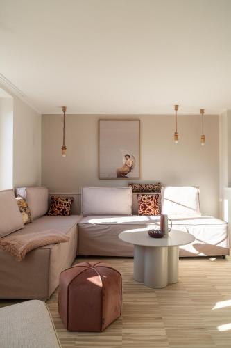 a living room with a couch and a table at RentPlanet - Apartamenty Rynek in Wrocław