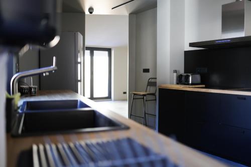 a kitchen with a sink and a counter top at KY Mountain Hostel Arinsal in Arinsal