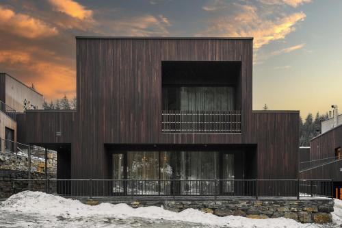 a wooden building with a balcony in the snow at Chalet Velvet by Fomich in Palyanytsya