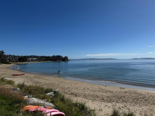 a beach with a group of boats on the shore at Rose Villa in Kingston Beach