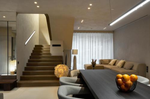 a living room with a table and a couch and stairs at Chalet Velvet by Fomich in Palyanytsya