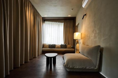 a living room with a couch and a chair and a table at Chalet Velvet by Fomich in Palyanytsya