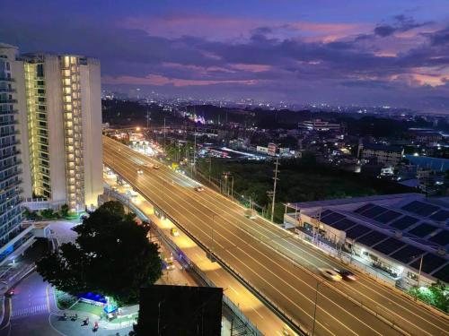 a view of a city at night with traffic at Skyrest Staycation - Azure Urban Resort in Manila