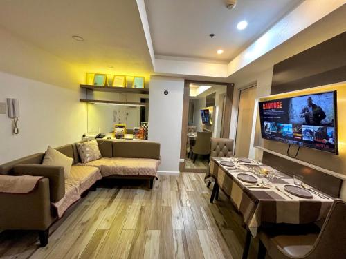 a living room with a couch and a table at Skyrest Staycation - Azure Urban Resort in Manila
