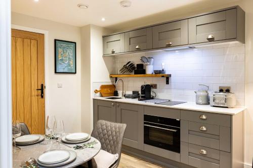 a kitchen with a table and a counter top at Rock Mill 1 Bed Apartment 27 in Stoney Middleton