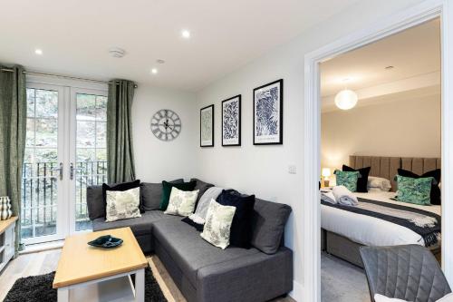 a living room with a couch and a bed at Rock Mill 1 Bed Apartment 27 in Stoney Middleton