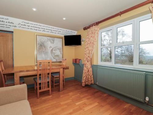 a dining room with a table and a window at Suite 2 in Stroud