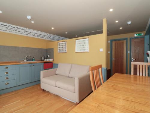 a living room with a couch and a table at Suite 2 in Stroud