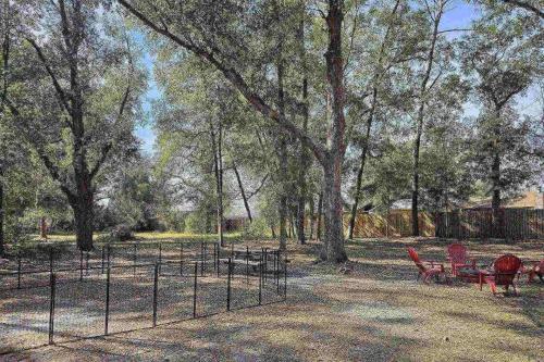 a park with chairs and a fence and trees at Moody Oaks in Orange Park