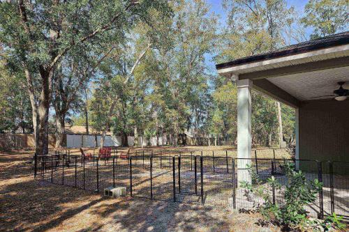 a gate in front of a park with trees at Moody Oaks in Orange Park