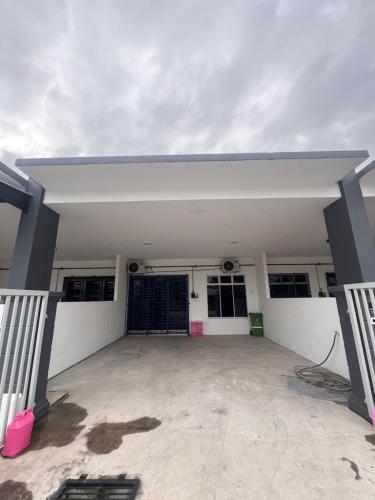 a view of a garage with its doors open at Dang Anum Homestay Kuantan Airport HalalHome in Kuantan