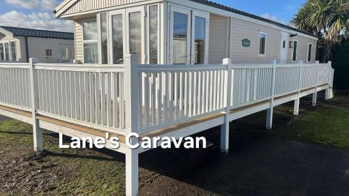 a house with a white railing on a porch at Southview holiday park caravan in Skegness