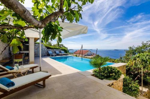 a villa with a pool and a view of the ocean at Elegant Sea-View Villa with Pool in Mlini