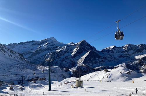 a ski lift in front of a snow covered mountain at Tchambre in Brusson