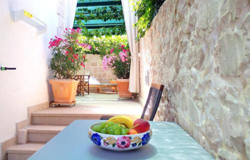a bowl of fruit sitting on a table on a table at Apartment Ennio in Povlja