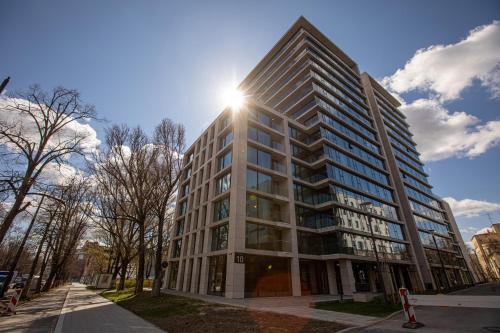 a tall building with the sun shining on it at EASY RENT Apartments - Amber 10, Basen & SPA, Centrum Free Parking 24h Check-in in Lublin