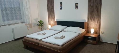 a bedroom with a bed with two towels on it at Penzion Starr in Havlickuv Brod