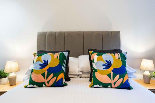 a bedroom with a bed with two pillows at Rock Mill 1 Bed Apartment 32 in Stoney Middleton