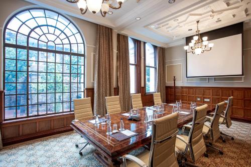 a conference room with a long table and chairs at Taj Cape Town in Cape Town