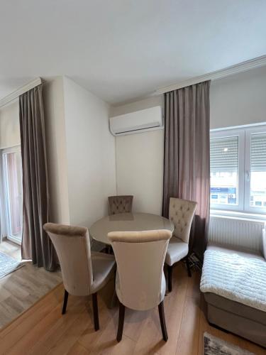 a room with a table and chairs and a bed at Apartmani sara in Plav