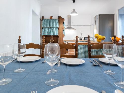 a table with wine glasses on a blue table cloth at Casa La Regidora in Cinco Casas