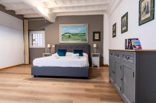 a bedroom with a bed with blue pillows at Elegantis Monti Suite Apartment in Rome