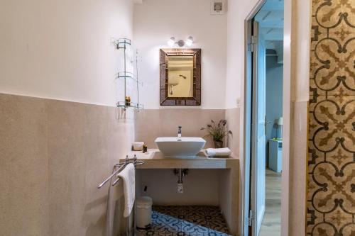 a bathroom with a sink and a mirror at Elegantis Monti Suite Apartment in Rome