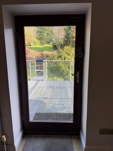 a glass door with a view of a patio at The Stables East Lodge Country House in Great Rowsley