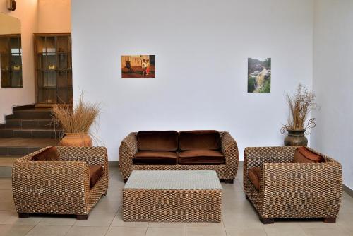 a living room with three chairs and a couch at Riviera Garden in Antananarivo