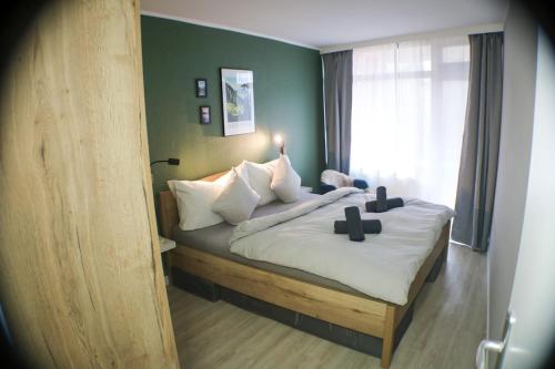 a bedroom with a bed with two crosses on it at Schönhier - Design Apartment mit Pool, Sauna in Schluchsee