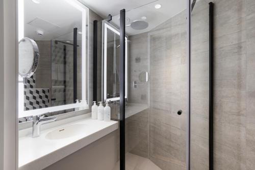 a bathroom with a sink and a shower at Original Sokos Hotel Vantaa in Vantaa