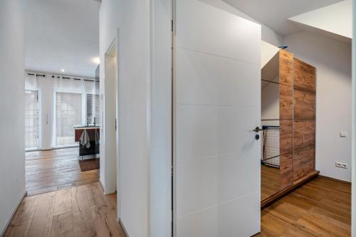 a room with white walls and a sliding door at City Villa Bad Dürrheim - Penthouse in Bad Dürrheim