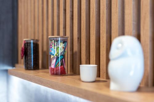 a shelf with a vase and two cups on it at Apartmány u Sjezdovky in Pernink