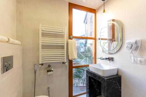 a bathroom with a sink and a window at Palm Tbilisi Boutique Hotel in Tbilisi City